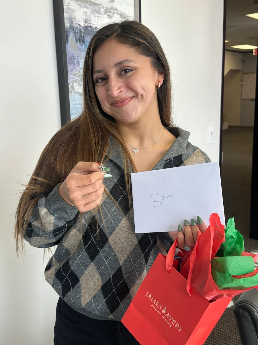 A GA Jersey Village team member with a recognition gift