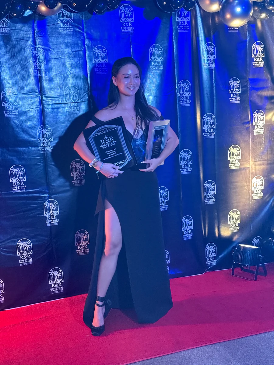 A GA Jersey Village team member with awards on the red carpet