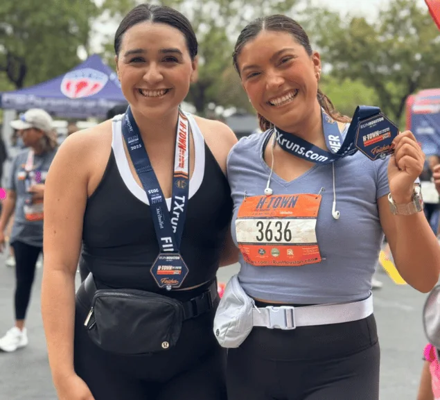 GA Jersey Village team members with finisher medals at a Houston community race